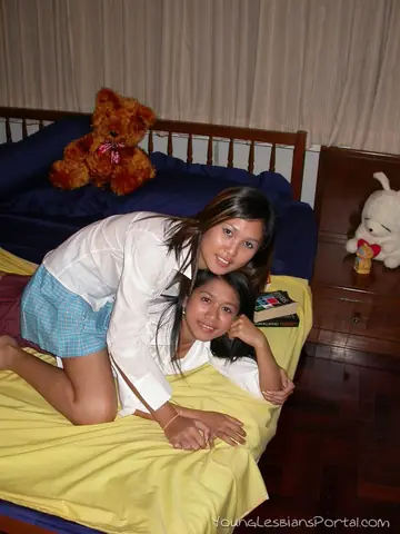 Asian Brunettes Kiss and Finger in Skirts on the Bed