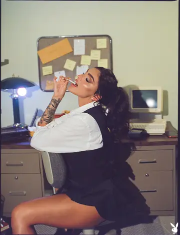 Brunette in a Skirt and High Heels Flaunts Her Enhanced Tits and Tattoos