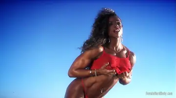 Alexis Ellis – Busty Curly Babe Shows Pierced Navel and Ass in a Bikini on the Beach