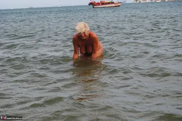 Slim Mature Blonde Strips Out of Her Shorts on the Beach