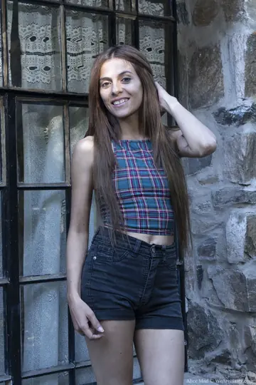 Alice Mad – Slim Brunette Pulls Shorts Aside to Show Her Hairy Pussy Outdoors