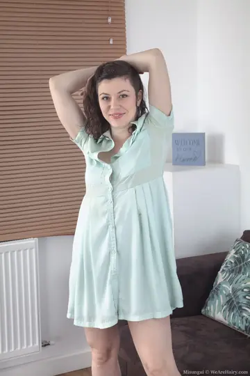 Hairy Brunette Spreads Her Pussy on the Sofa in Heels