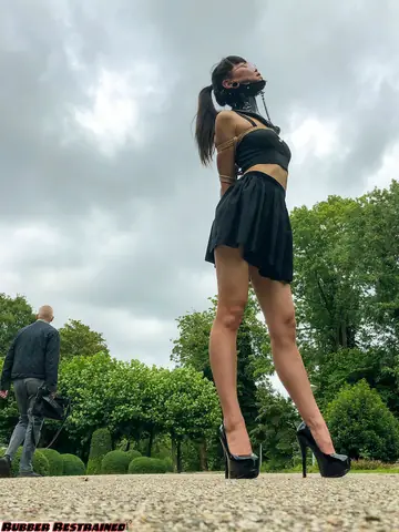 Asian Woman Bound in a Skirt and Heels in Public Park