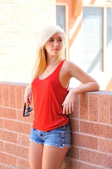 Blonde in Pigtails and Socks Strips Outdoors