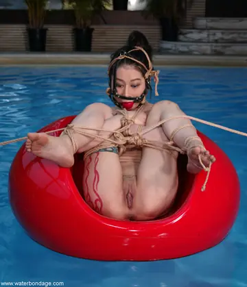 Tall Asian Woman Bound in Water Bondage
