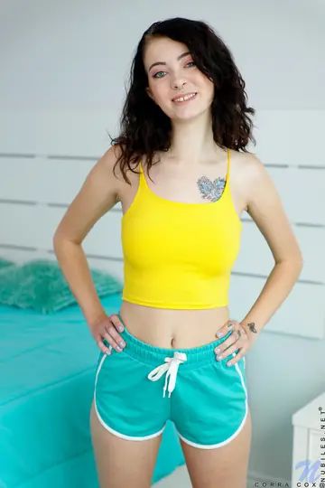 Corra Cox – Slim Brunette Strips Out of Her Shorts and Spreads Her Ass on the Bed