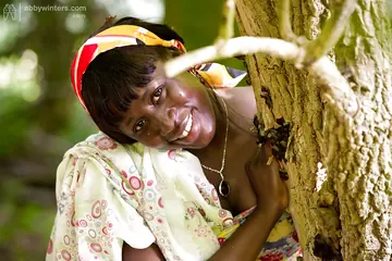 Mature Ebony Woman Undresses and Spreads in the Forest