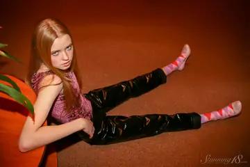 Redhead in Latex Pants Bares Her Tits and Ass Then Spreads Her Pussy