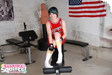 Sabrina Squirts – Tattooed Brunette Squirts in Socks on a Weightlifting Bench
