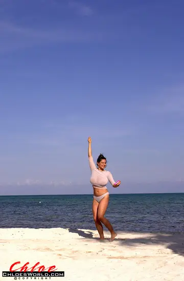 Chloe Vevrier – Thick Brunette MILF in Pigtails Strips Out of Her Bikini on the Beach