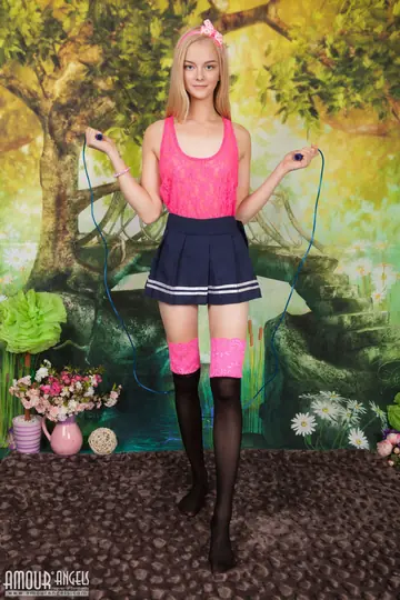 Slim Blonde in a Skirt and Socks Spreads Her Shaved Pussy