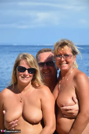 Sweet Susi – Two Curvy MILFs in Glasses Share a Man in a Threesome on the Beach