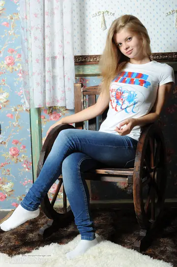 Blonde in Socks Strips Naked on a Chair and Spreads Her Shaved Pussy