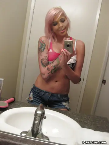 Busty Tattooed Woman Strips Out of Her Shorts for Bathroom Mirror Selfies