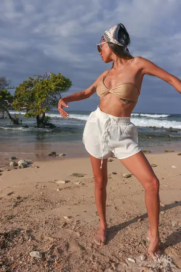 Latina in Shorts and Glasses Shows Her Big Natural Tits on the Beach