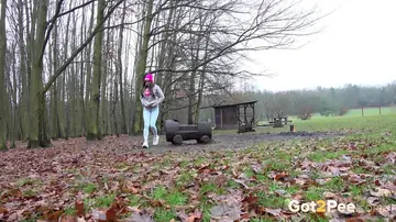 European Woman Pisses in Jeans and Glasses Outdoors