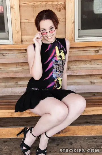 Skinny Short-Haired Woman in a Skirt and Glasses Gives a Handjob
