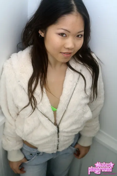 Asian Woman Pulls Down Her Jeans to Reveal a Bikini – photo 2 of 12