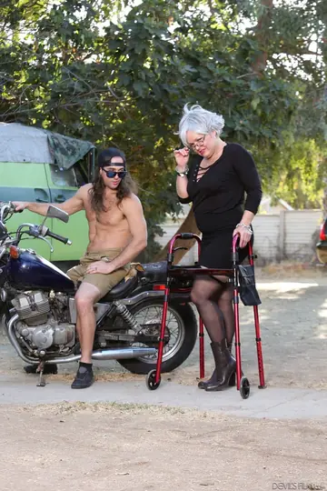Mature Blonde MILF Strips Outdoors with Her Walker