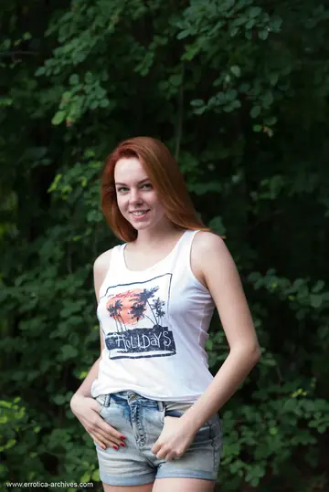 Candy Red – Redhead with Natural Tits Spreads Outdoors by Water