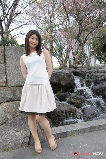 Japanese Brunette Poses Outdoors in a Skirt and High Heels