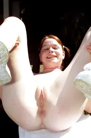 Redhead in Pigtails Spreads Her Shaved Pussy Outdoors