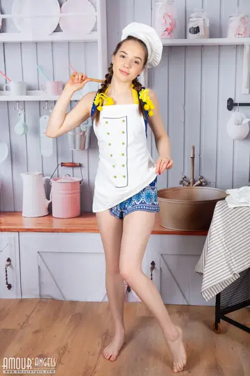 Skinny Woman in a Skirt Strips and Spreads in the Kitchen