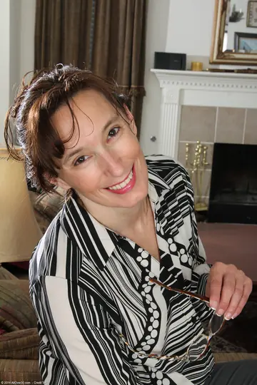 Brunette MILF Strips Off Her Stockings and Fingers Her Pussy