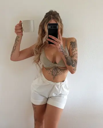 Tattooed Woman Poses in Clothed Solo Set