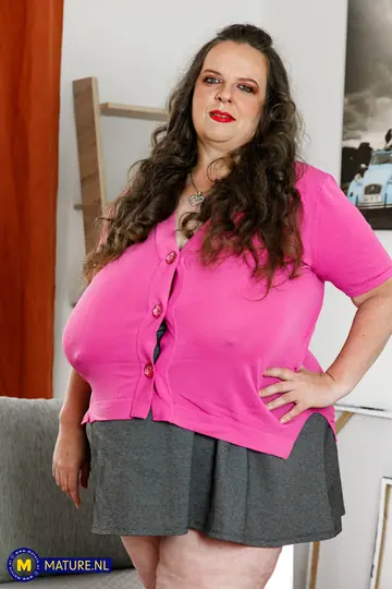 Mature Chubby Woman with Big Tits Masturbates with a Toy on the Sofa