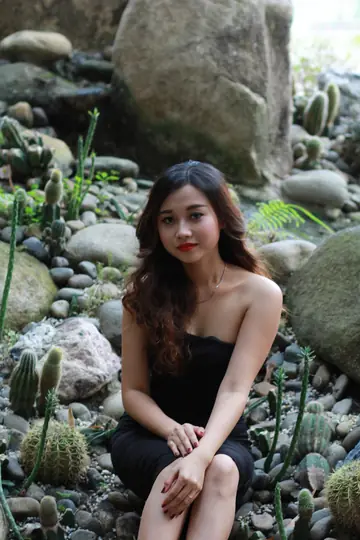 Petite Asian Woman Shows Her Legs in a Dress Outdoors