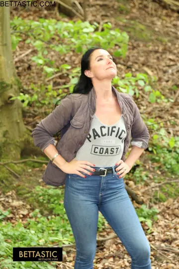 Brunette Poses Outdoors in Jeans