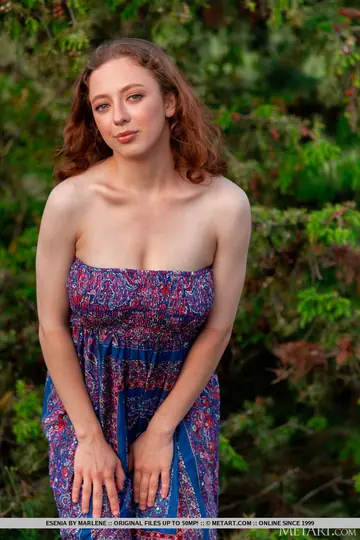 Busty Woman Strips Out of Her Dress in the Forest