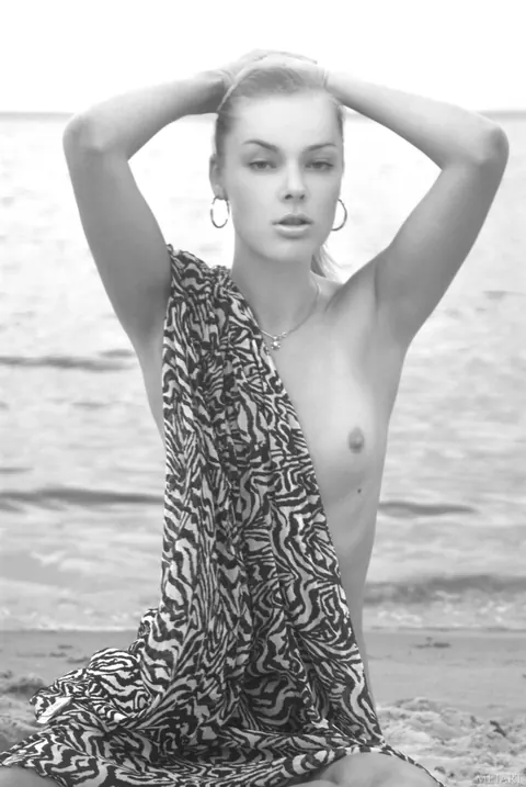 Blonde Undresses and Poses Nude on the Beach – photo 19 of 21