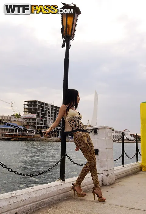 Brunette in Heels and Tight Pants Poses Outdoors – photo 15 of 16