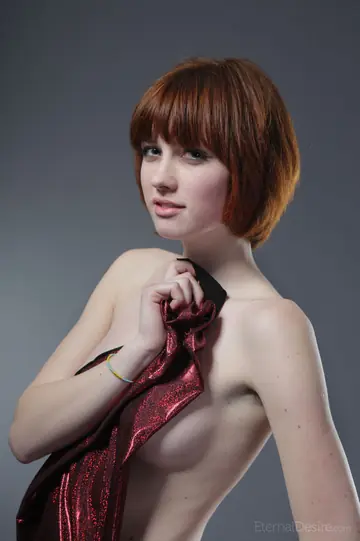 Slim European Redhead Spreads Her Shaved Pussy on a Studio Chair