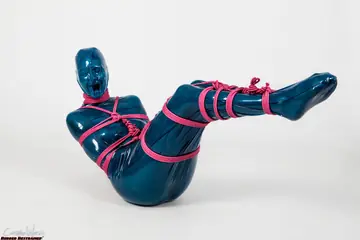 Brunette Restrained in Latex with Pink Rope