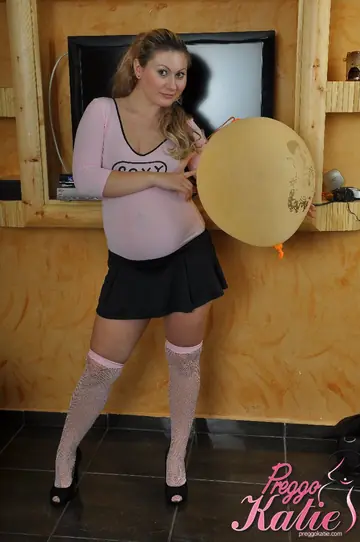 Pregnant Woman Strips Out of Her Stockings and Skirt