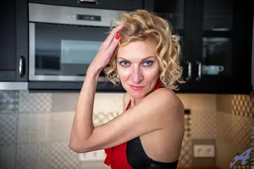 Mature Woman in Lingerie Fucks Herself with a Cucumber on the Kitchen Counter