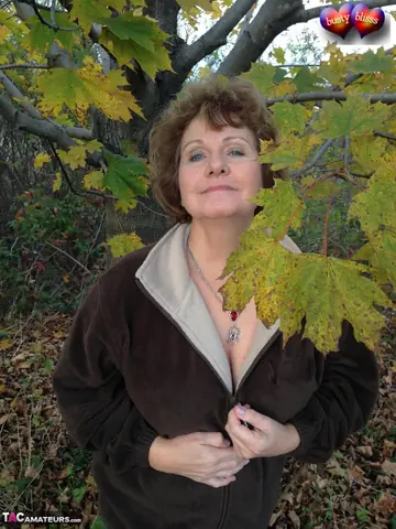 Bustybliss – Mature Curvy Brunette Undresses Outdoors Under a Tree