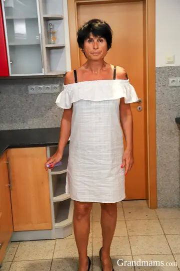 Busty Mature Brunette Shows Her Tattooed Body in the Kitchen
