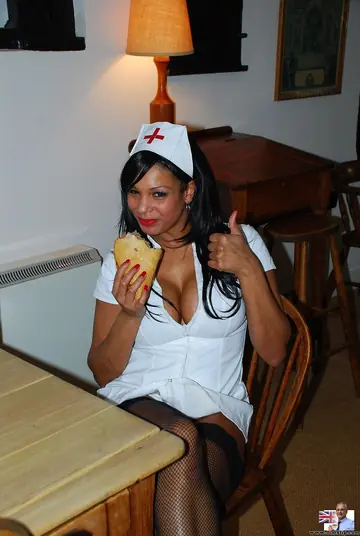 Ebony Nurse in Uniform and Stockings Fingers Herself