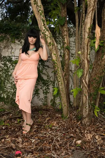 Busty Trans Woman Poses in a Skirt Outdoors