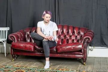 Short-Haired Woman Spreads Her Toes in Jeans and Socks