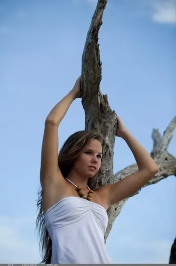 Woman Undresses and Poses Nude on Her Knees and Back