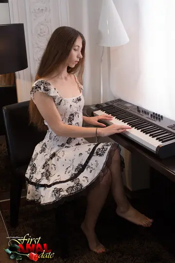 Slim Brunette in a Dress Takes Anal by the Piano