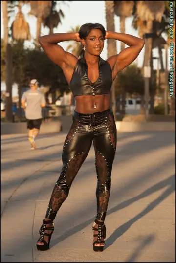 Ebony Bodybuilder in Leather and High Heels Walks Outdoors