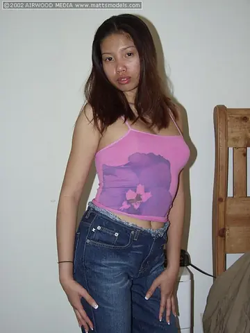 Asian Woman Lowers Her Jeans and Spreads Her Shaved Pussy