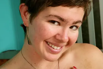 Short-Haired Brunette Peels Off Her Clothes and Spreads Her Hairy Pussy