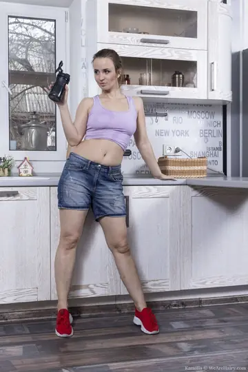 Woman Strips in the Kitchen and Masturbates Hairy Pussy with a Dildo